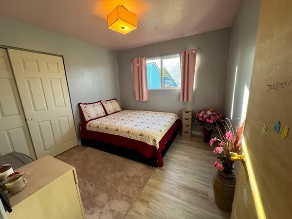 a bedroom with a bed and a flat screen tv