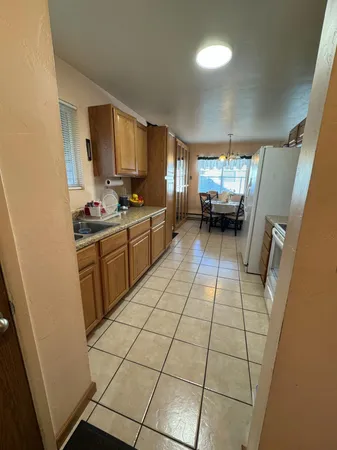a kitchen with stainless steel appliances a sink a stove top oven a counter space and cabinets