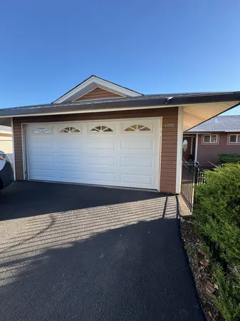 a view of a parking space in front of a house