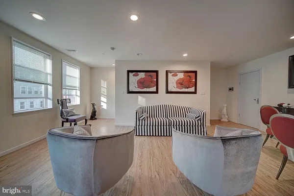 a living room with furniture wooden floor and a painting