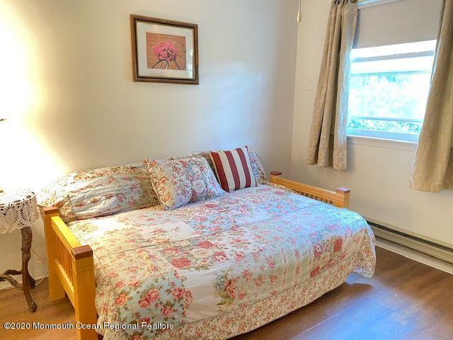 136 B Sunset Road Whiting, NJ 08759 - Photo 12 of 16 a bedroom with a bed and wooden floor