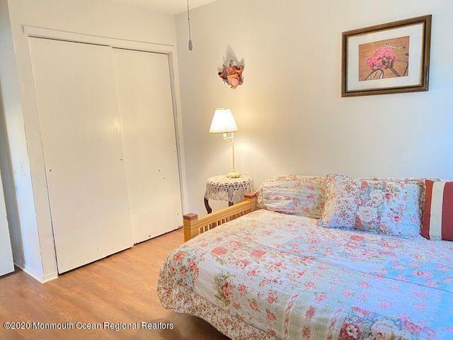 136 B Sunset Road Whiting, NJ 08759 - Photo 13 of 16 a bedroom with a bed and a painting on the wall