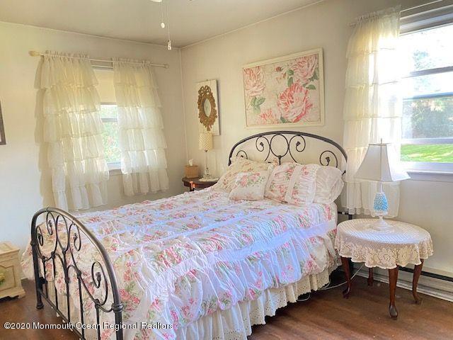 136 B Sunset Road Whiting, NJ 08759 - Photo 14 of 16 a bedroom with a bed and a table in it