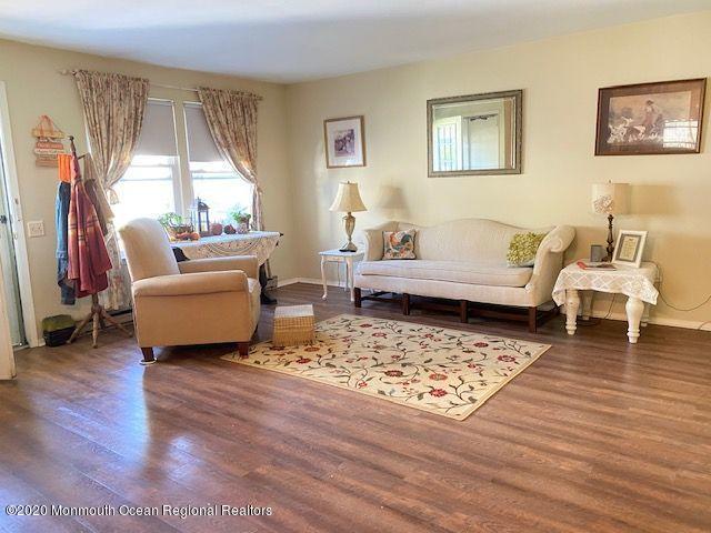 136 B Sunset Road Whiting, NJ 08759 - Photo 4 of 16 a living room with furniture and a large window