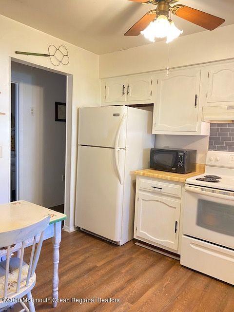 136 B Sunset Road Whiting, NJ 08759 - Photo 8 of 16 a kitchen with a refrigerator and white cabinets