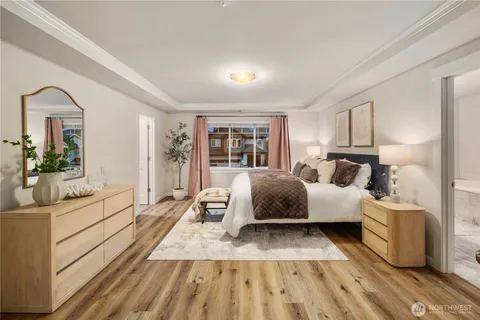 a bedroom with a large bed and a couch