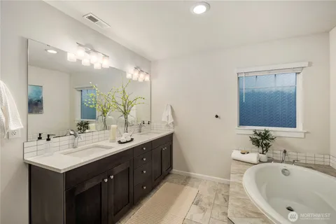 a bathroom with a double vanity sink and a mirror