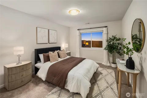 a bedroom with bed and a potted plant