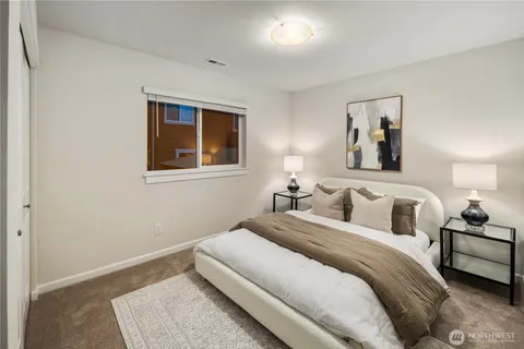 a bedroom with a large bed and a window