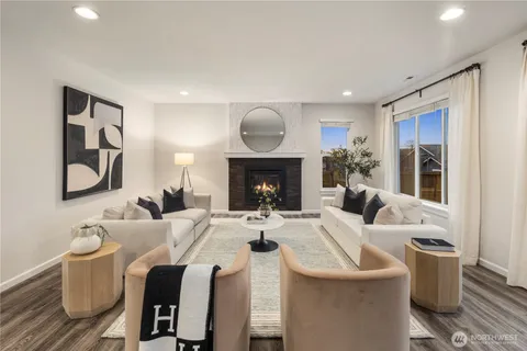 a living room with furniture a fireplace and wall paintings