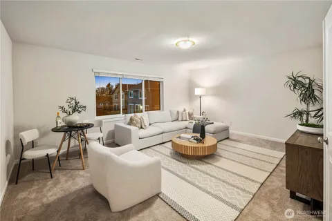 a living room with furniture and a potted plant