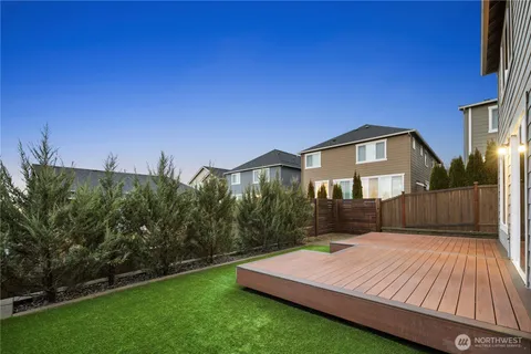 a view of an house with backyard and sitting area