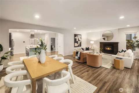 a living room with fireplace a table and chair