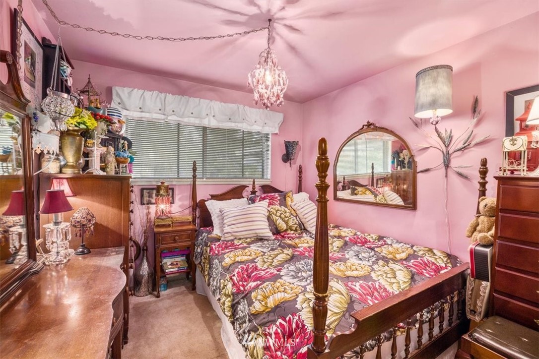 222 219th Place Southwest Bothell, WA 98021 - Photo 14 of 24 a bed room with a bed mirror and a chandelier