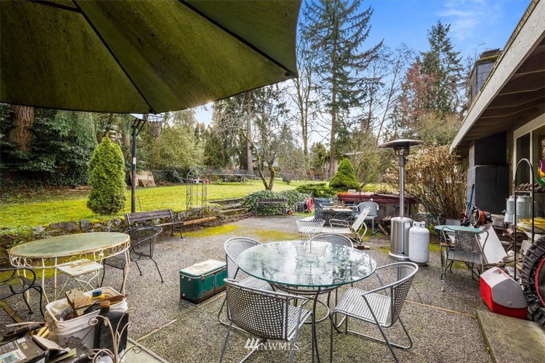 222 219th Place Southwest Bothell, WA 98021 - Photo 16 of 24 a view of a patio with chairs and table under an umbrella