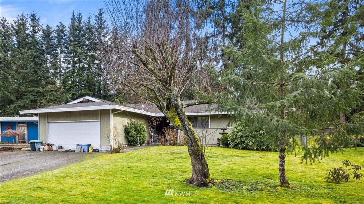 222 219th Place Southwest Bothell, WA 98021 - Photo 24 of 24 a front view of a house with a yard garage and trees