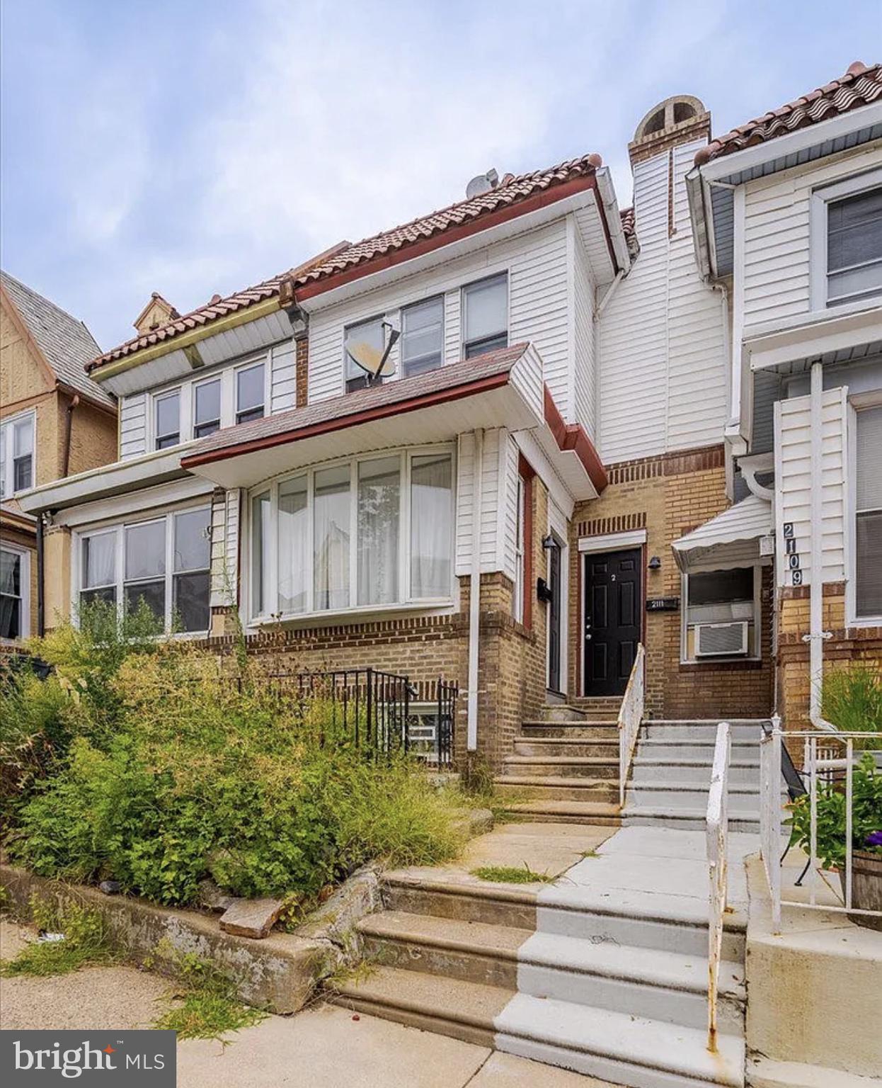 2111 North Wanamaker Street, Unit 2 Philadelphia, PA 19131 - Photo 9 of 10 a front view of a house with a yard