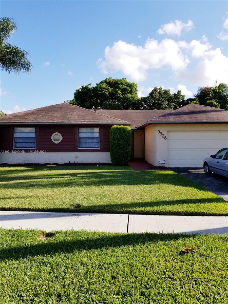a view of a big yard with a table and a chair