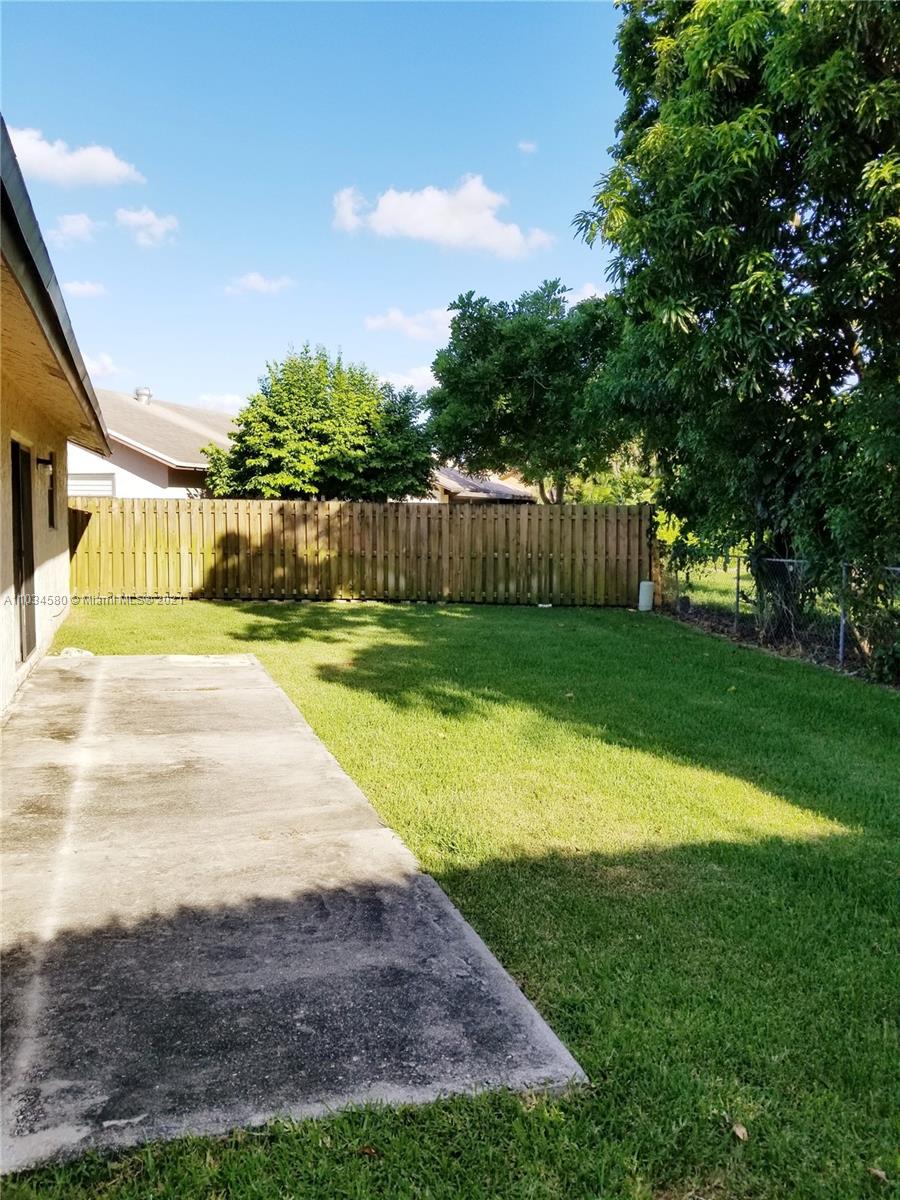Springtree Lakes Sunrise, FL 33351 - Photo 2 of 2 a swimming pool with wooden fence