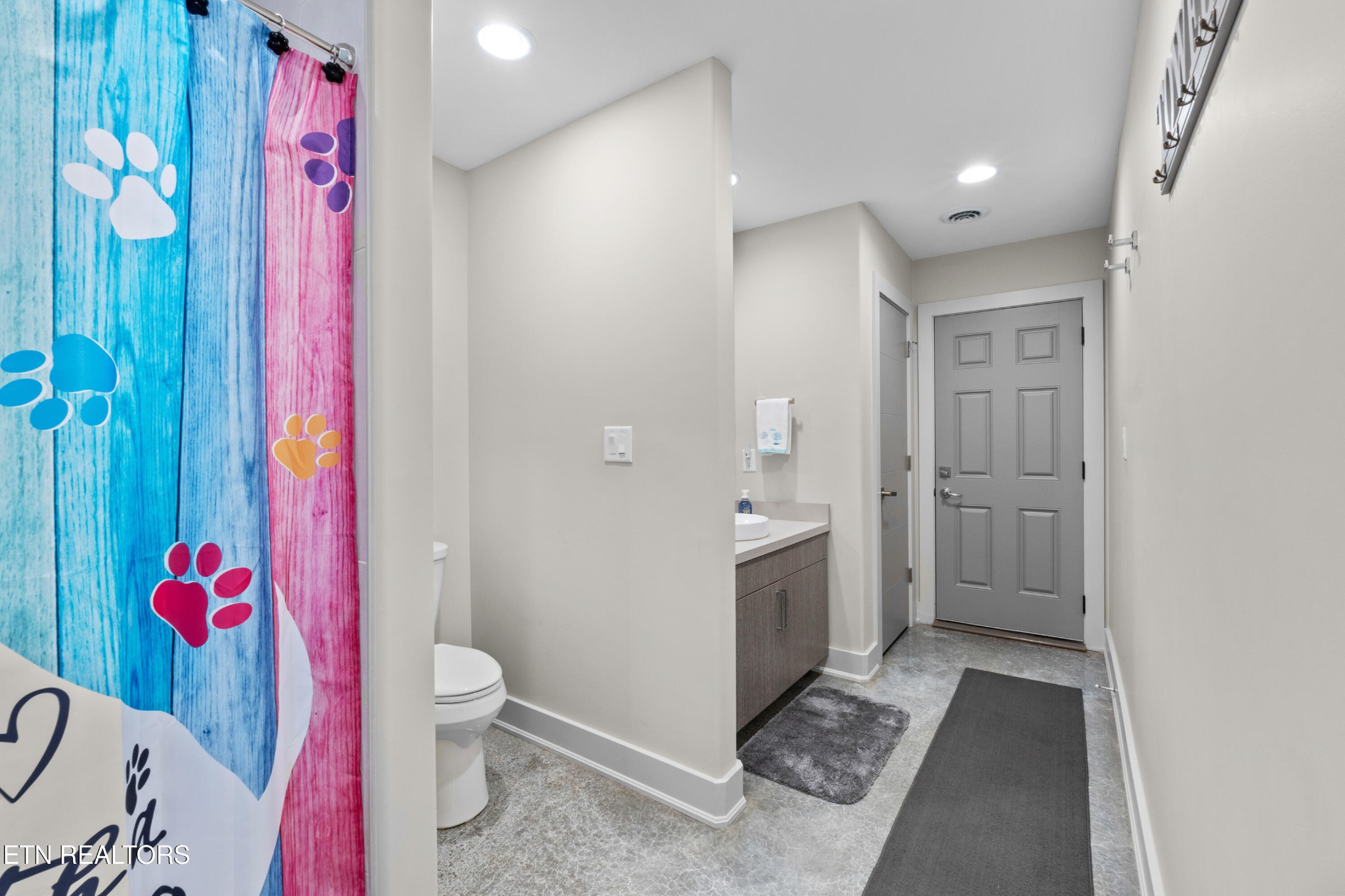 3702 Promontory Point Louisville, TN 37777 - Photo 45 of 60 a bathroom with a sink mirror vanity and toilet
