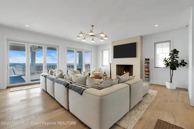 a living room with furniture and a chandelier