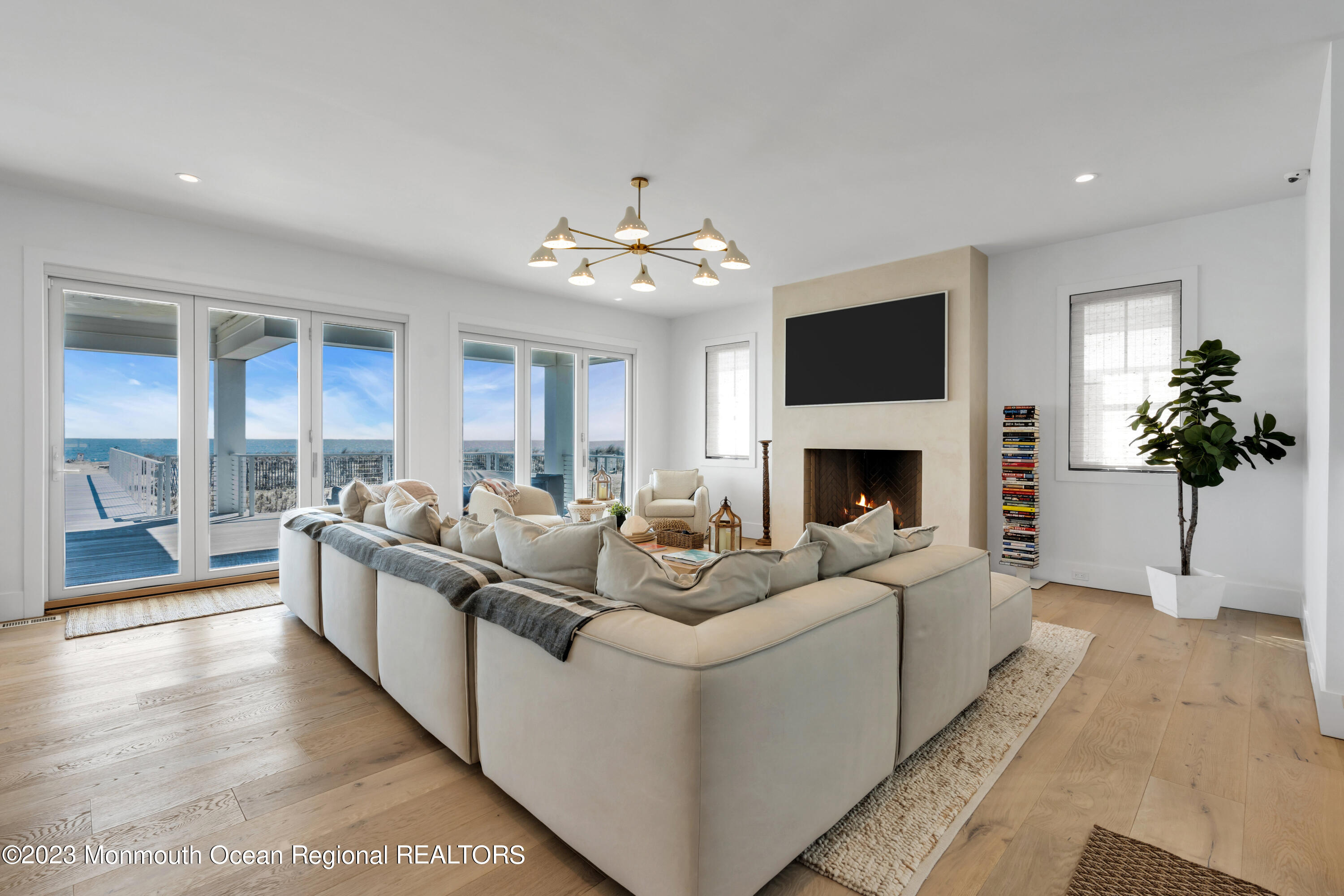 1125 North Ocean Avenue Mantoloking, NJ 08738 - Photo 12 of 69 a living room with furniture a fireplace and a potted plant