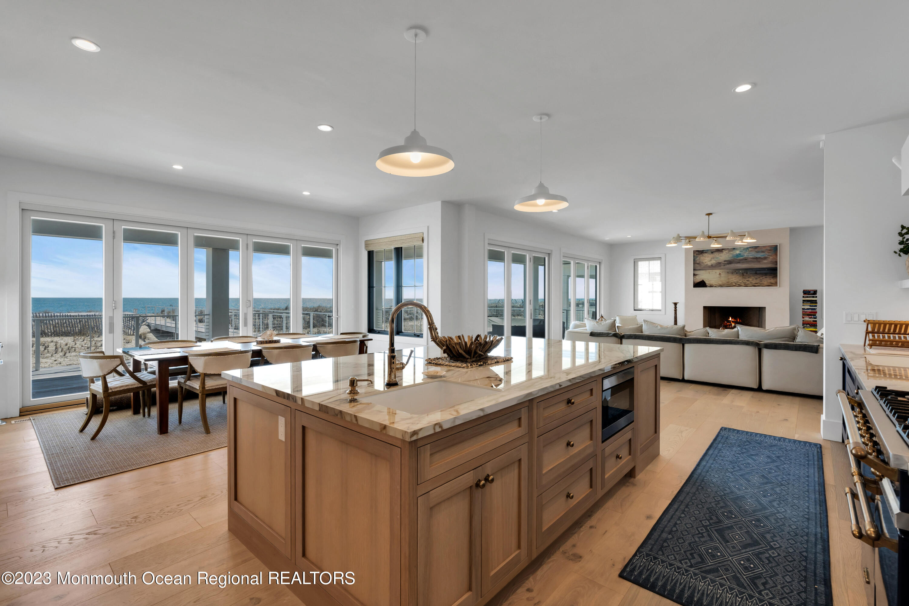 1125 North Ocean Avenue Mantoloking, NJ 08738 - Photo 17 of 69 a large kitchen with kitchen island a large counter top space a sink a stove and a view of living room