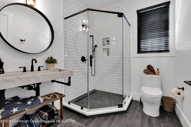 a spacious bedroom with a large bed couch and windows