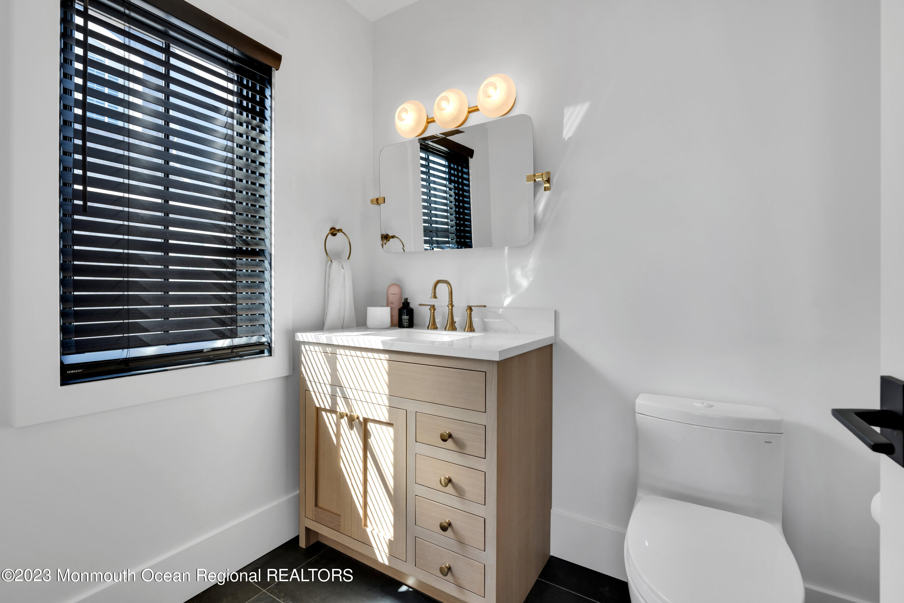 1125 North Ocean Avenue Mantoloking, NJ 08738 - Photo 38 of 69 a bathroom with a toilet sink and mirror