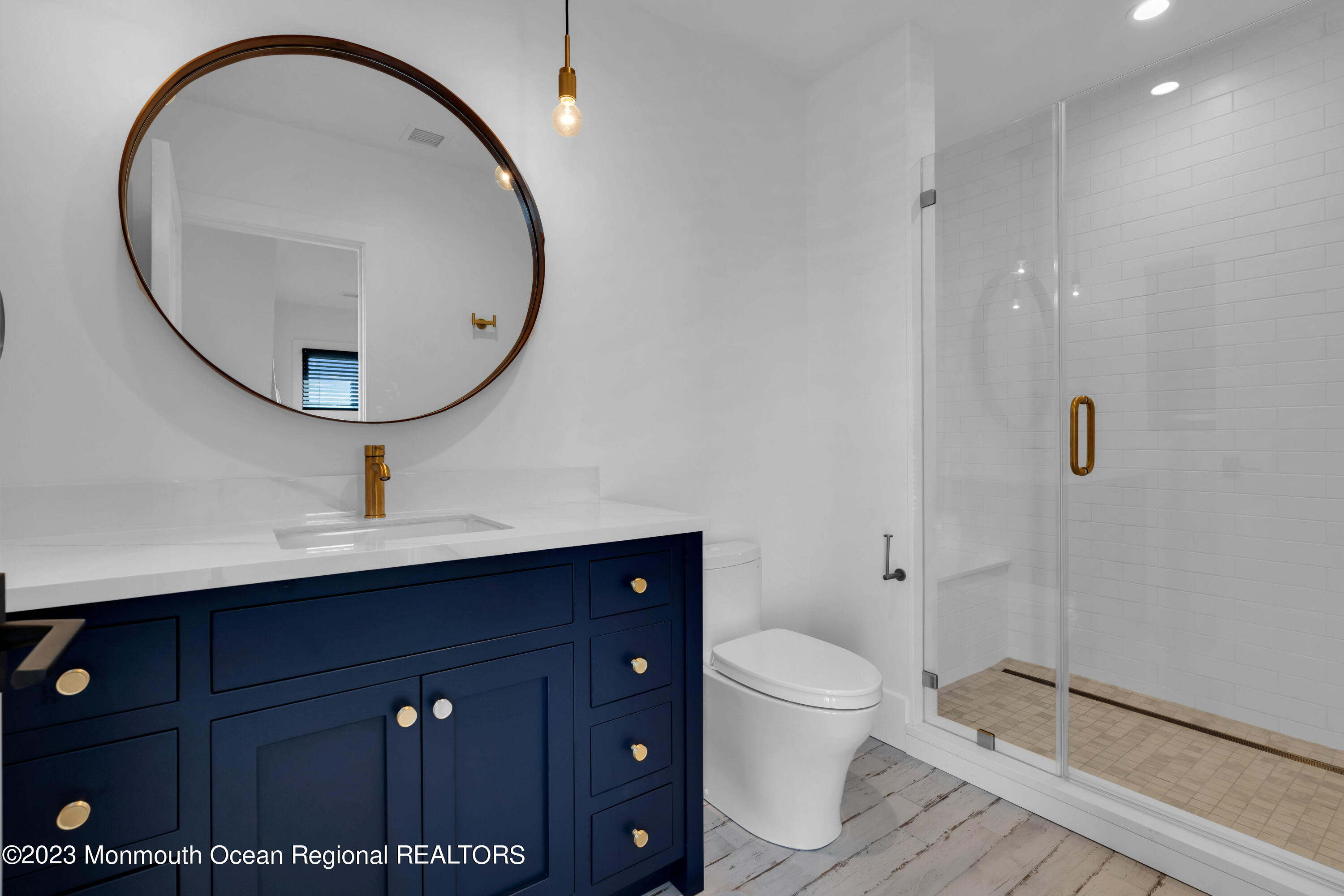 1125 North Ocean Avenue Mantoloking, NJ 08738 - Photo 42 of 69 a bathroom with a sink a toilet and a mirror