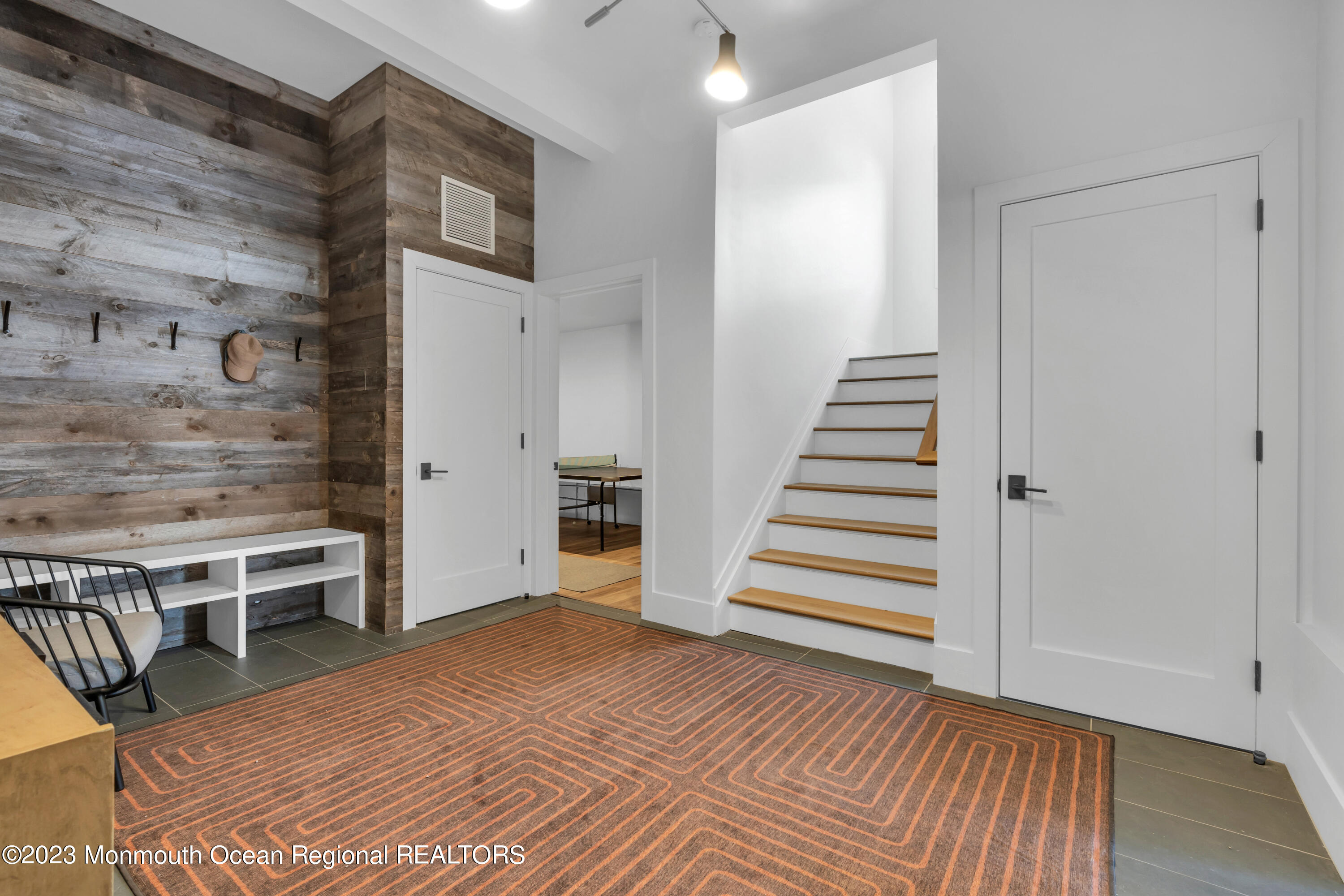 1125 North Ocean Avenue Mantoloking, NJ 08738 - Photo 52 of 69 a view of a livingroom with wooden floor and stairs