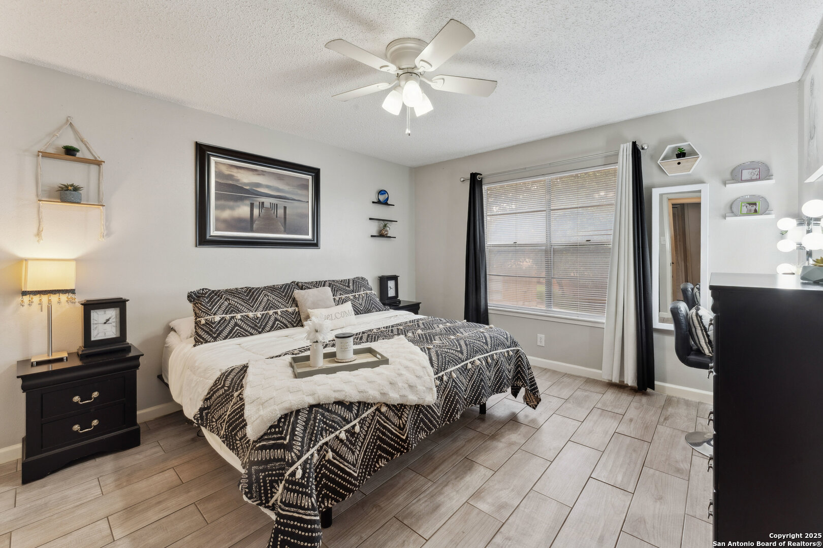 923 Vance Jackson Road, Unit 1104 San Antonio, TX 78201 - Photo 12 of 18 a bedroom with a bed and a chandelier
