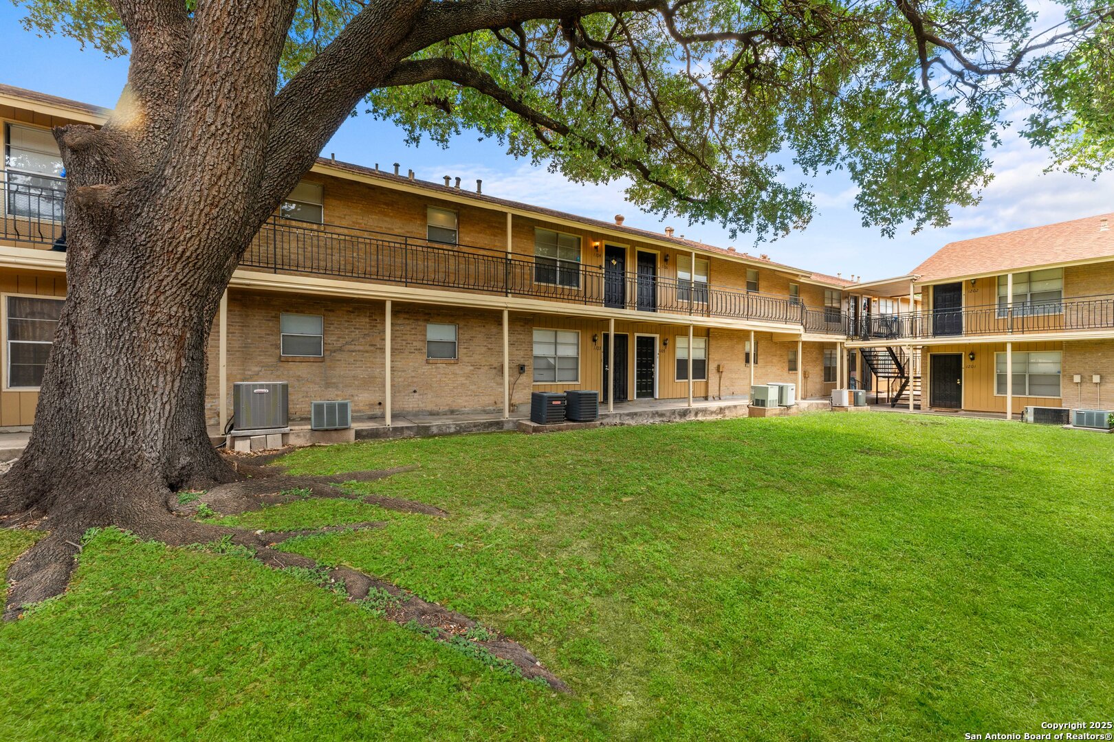 923 Vance Jackson Road, Unit 1104 San Antonio, TX 78201 - Photo 17 of 18 a front view of a house with a garden