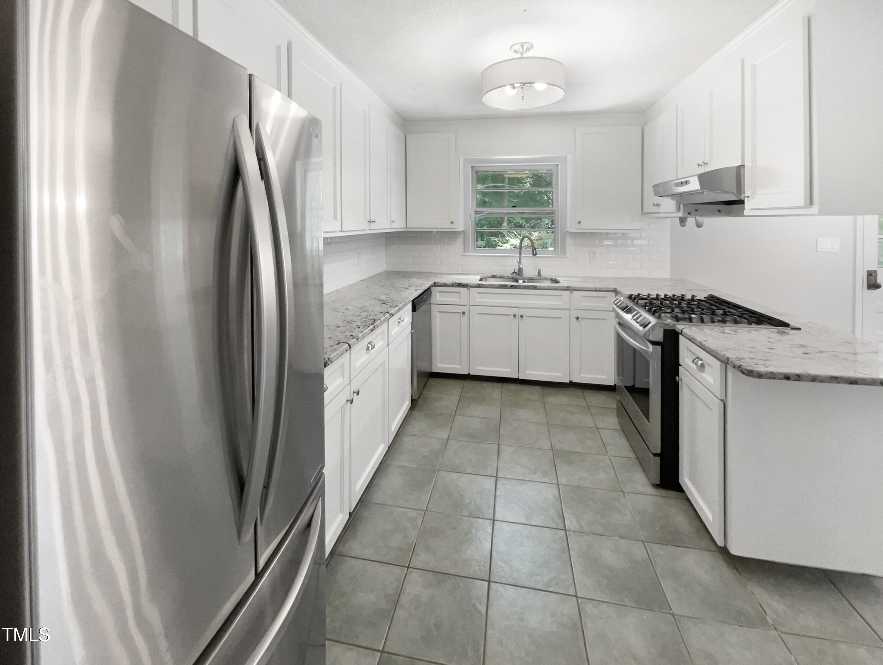 6310 Brandywine Road Raleigh, NC 27607 - Photo 6 of 22 a kitchen with stainless steel appliances granite countertop a refrigerator sink and white cabinets