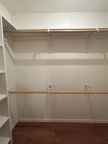 a bathroom with a granite countertop double vanity sink and mirror