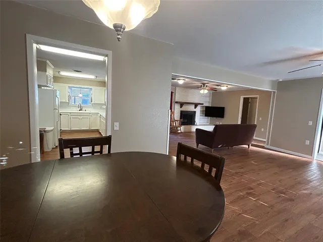 a living room with furniture and a dining table with kitchen view