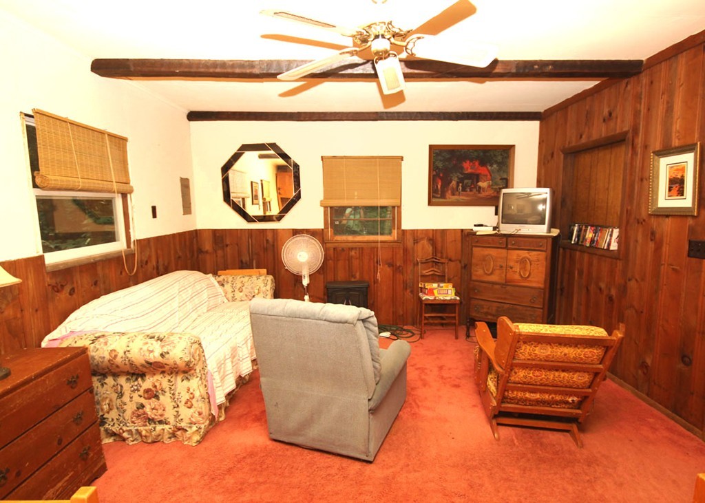 373 Stanley Road Otis, MA 01029 - Photo 6 of 14 a living room with furniture a window and a fireplace