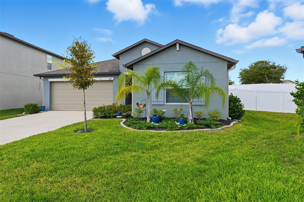 11675 Lavender Loop Spring Hill Spring Hill, FL 34609 - Photo 1 of 1 a view of a house with a big yard potted plants and large tree