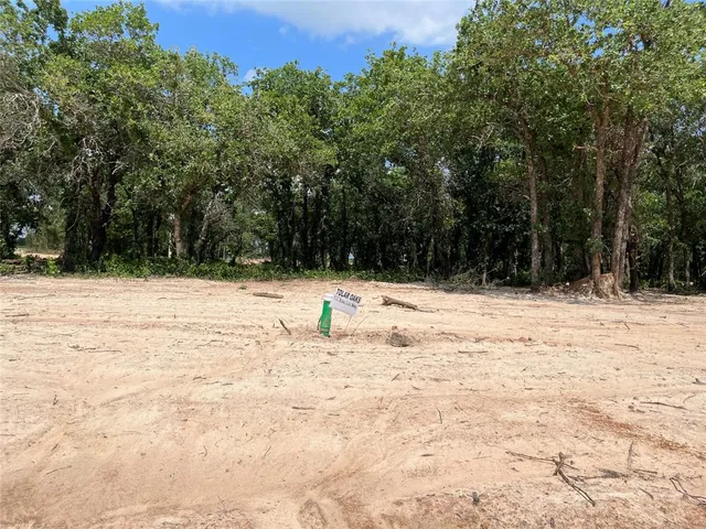 a view of side of snow with trees in the background