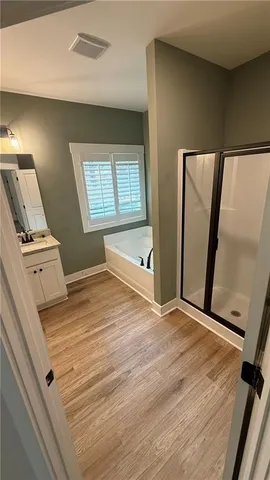 a view of an empty room and wooden floor