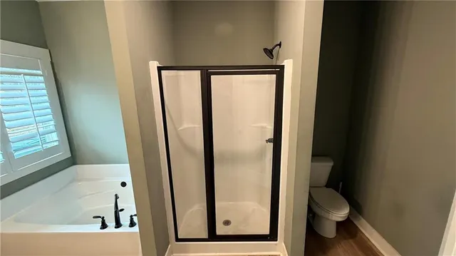 a bathroom with a tub and shower