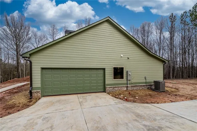 a view of backyard of house and garage