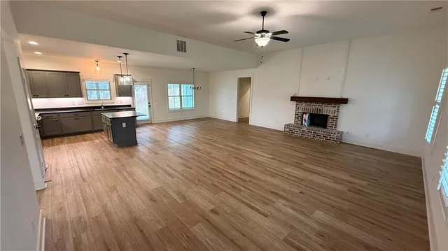 a view of kitchen with cabinets and wooden floor