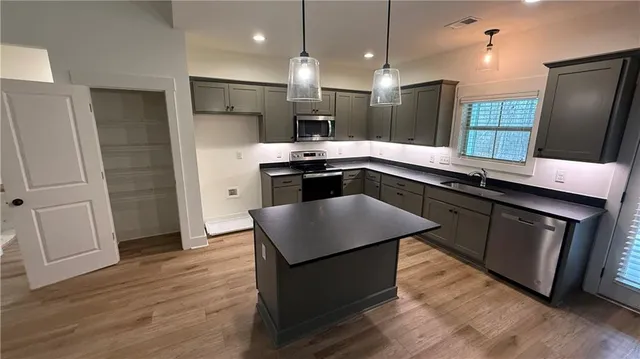 a kitchen with a sink and a refrigerator