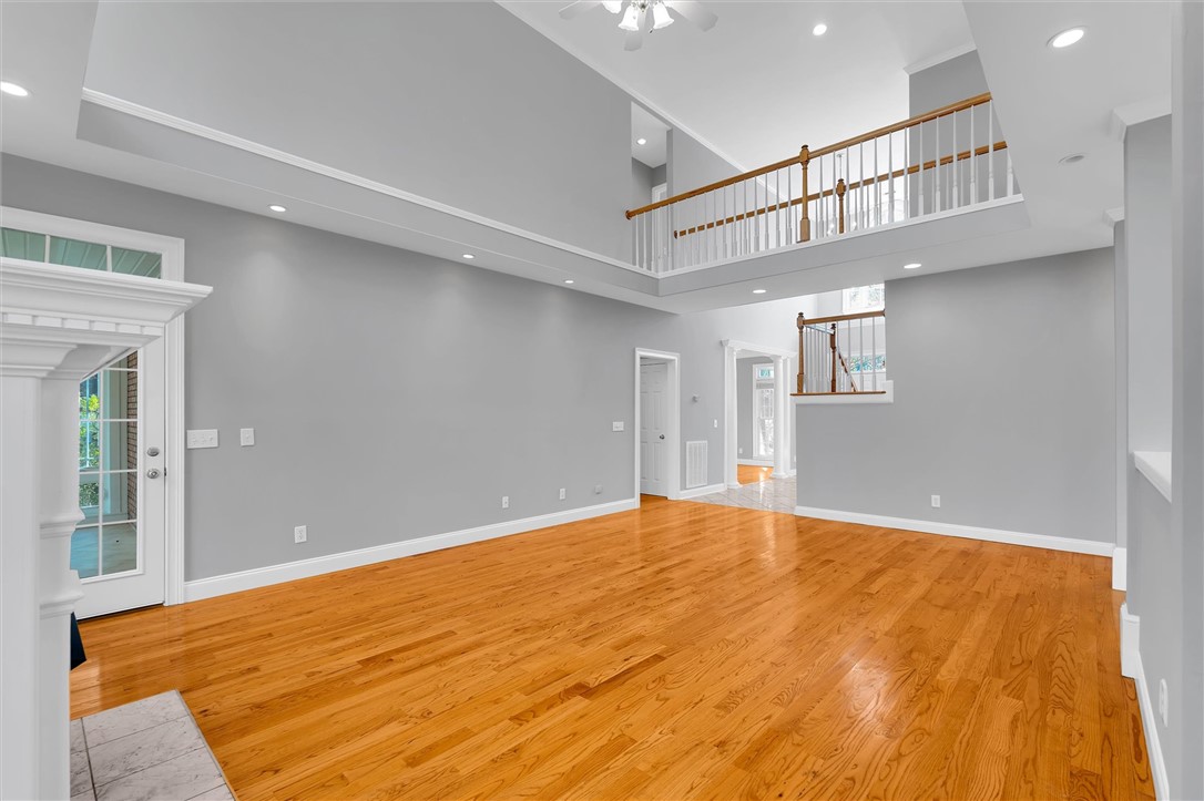 204 Red Maple Way Clemson, SC 29631 - Photo 7 of 48 This living room features high ceilings and polished hardwood flooring, perfect for gatherings.