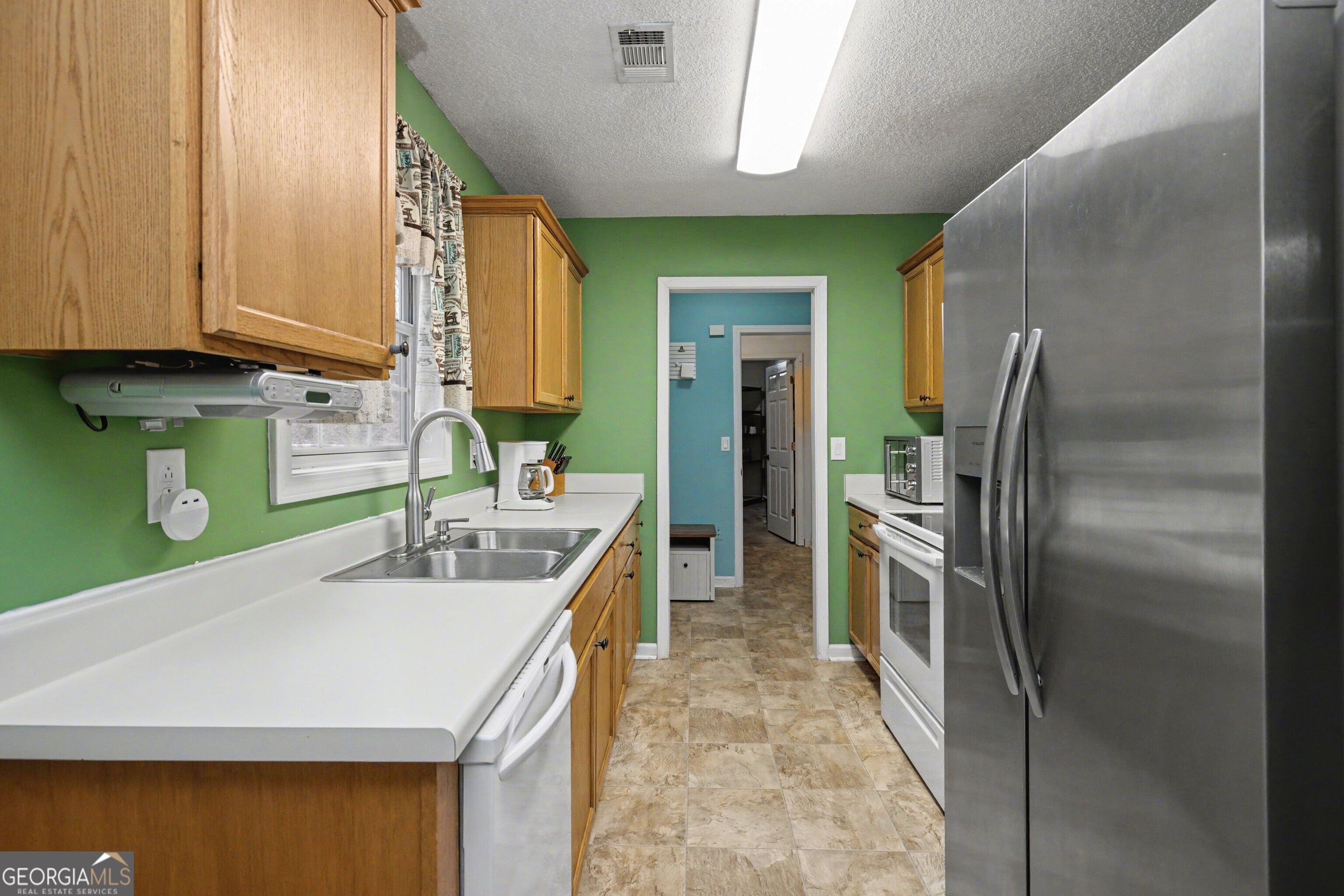 183 Buck Smith Road Hogansville, GA 30230 - Photo 12 of 28 a kitchen with kitchen island a sink stainless steel appliances and cabinets
