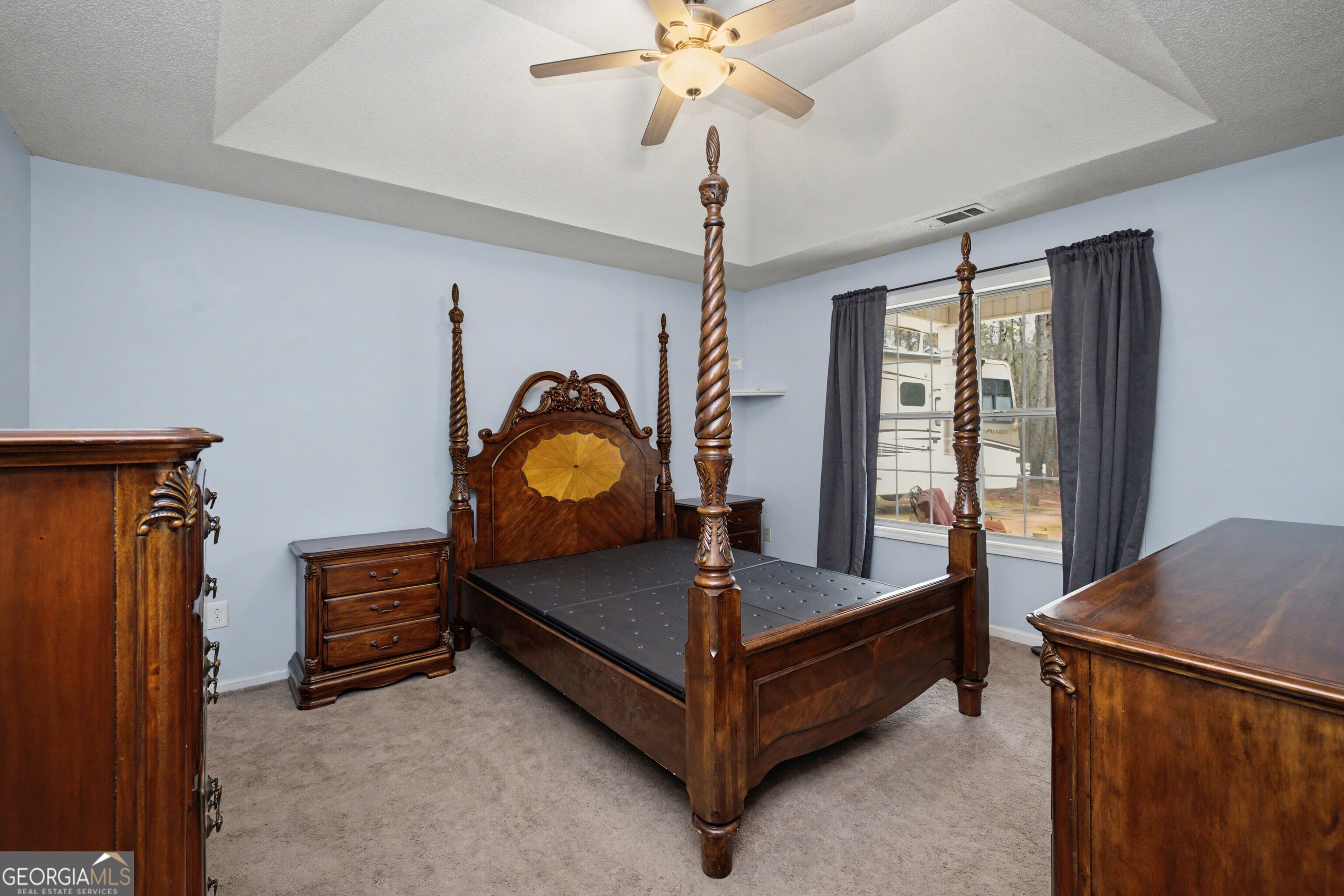 183 Buck Smith Road Hogansville, GA 30230 - Photo 13 of 28 a bedroom with a bed and a chandelier