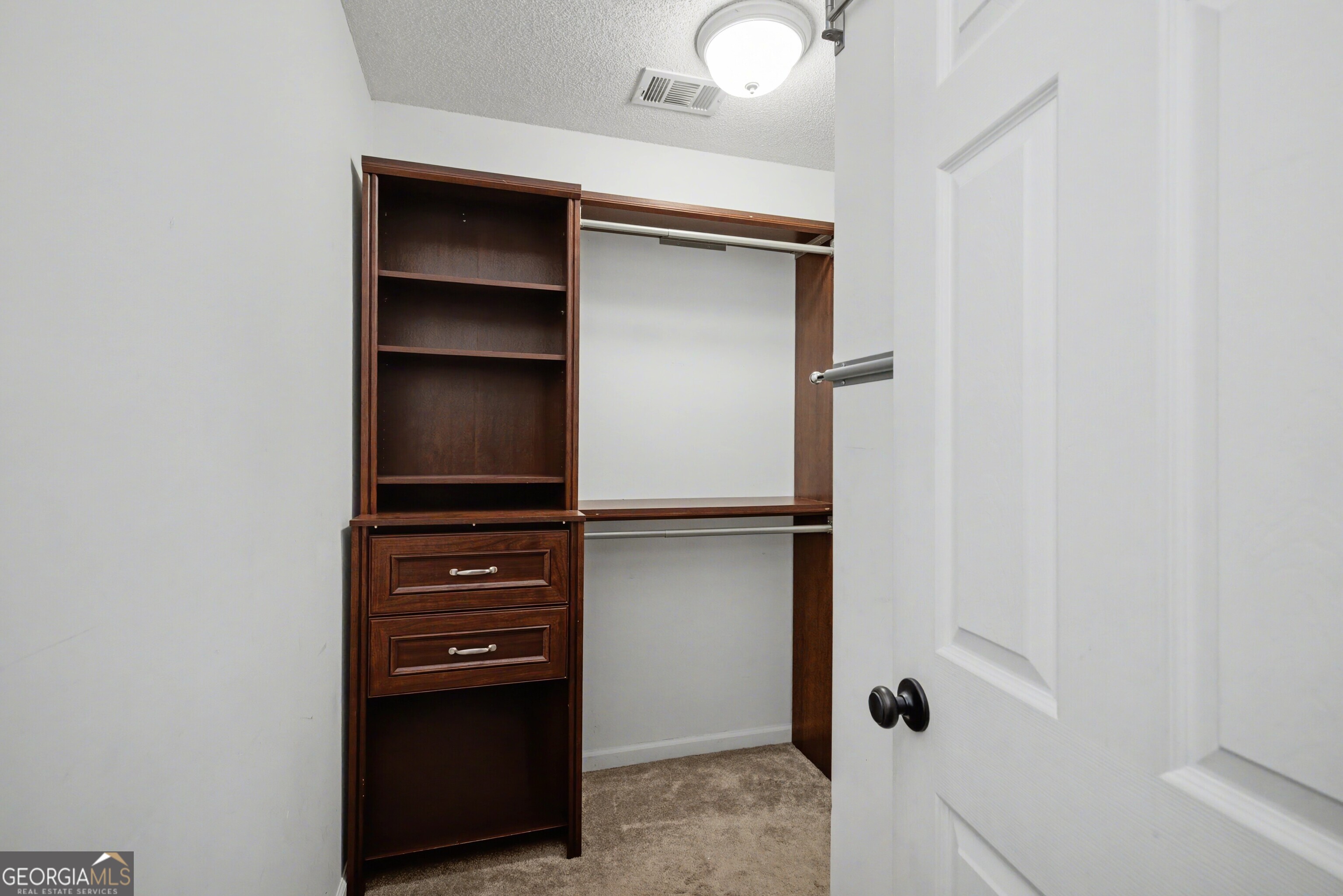 183 Buck Smith Road Hogansville, GA 30230 - Photo 16 of 28 a view of walk in closet with empty racks