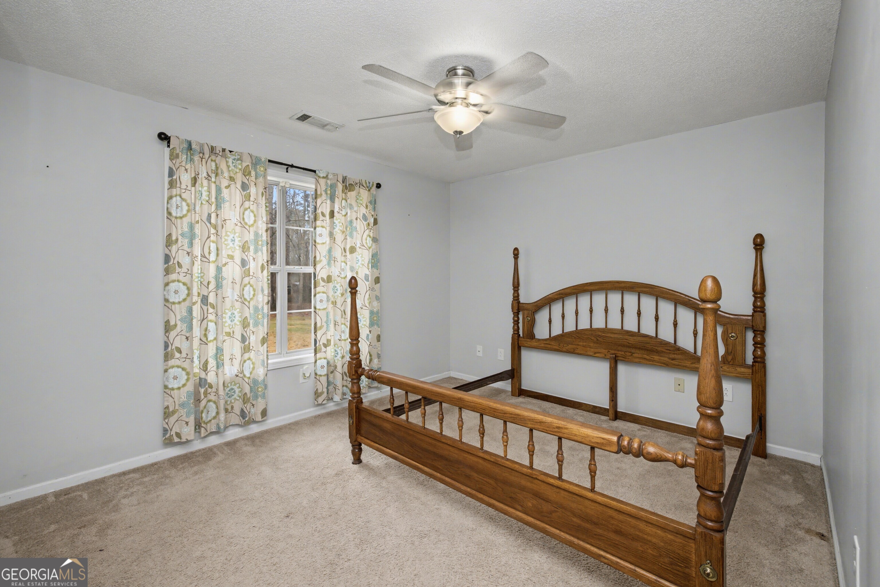 183 Buck Smith Road Hogansville, GA 30230 - Photo 17 of 28 a bedroom with furniture and a chandelier fan