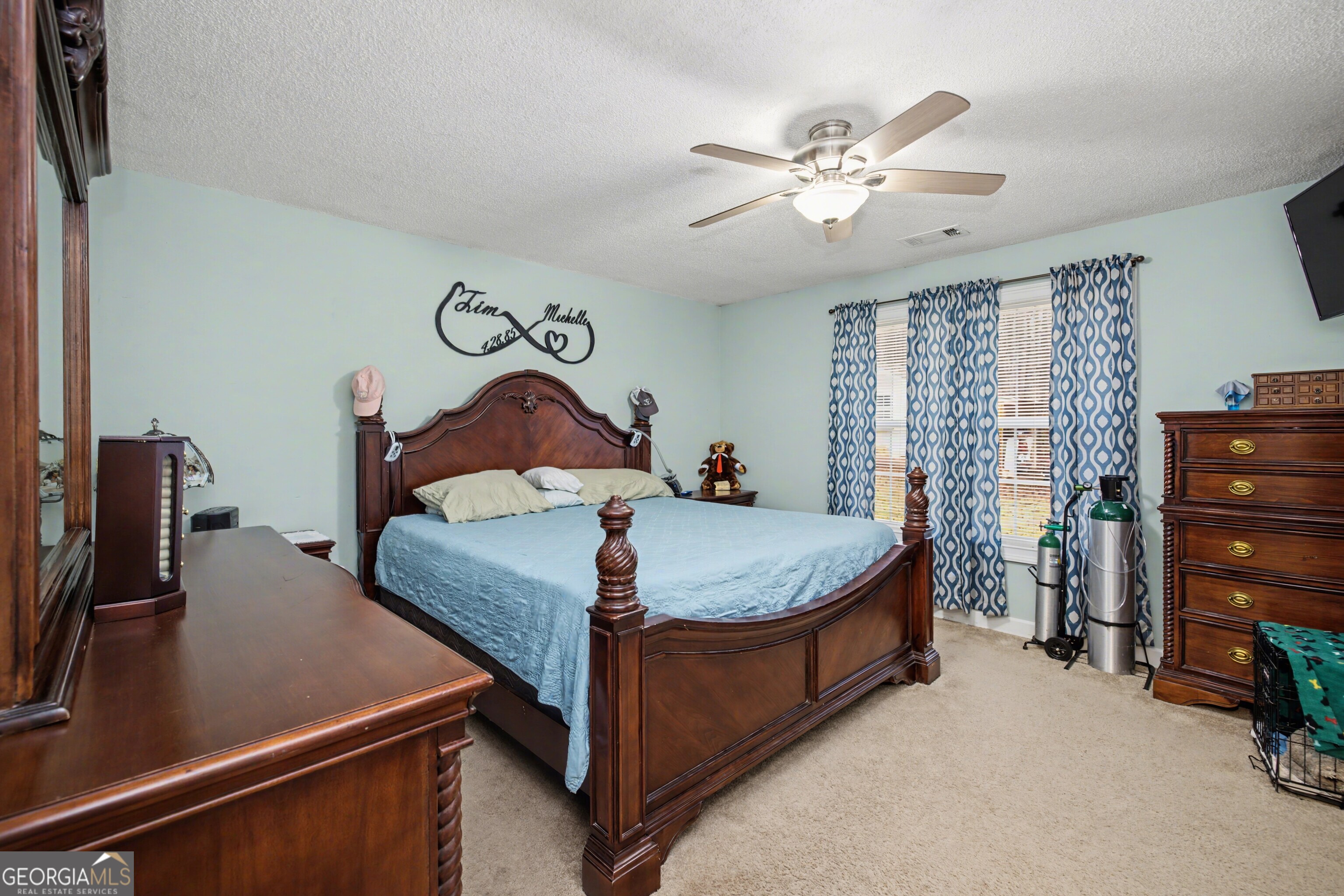 183 Buck Smith Road Hogansville, GA 30230 - Photo 18 of 28 a bedroom with a bed and ceiling fan
